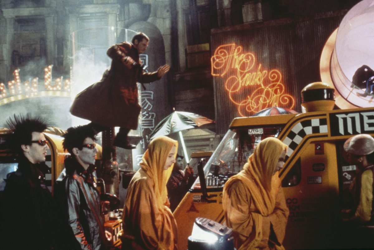 Blade Runner, Deckard (Harrison Ford) pursues Replicant, Zhora (Joanna Cassidy) through the crowded streets of a hellishly dystopian future Los Angeles
